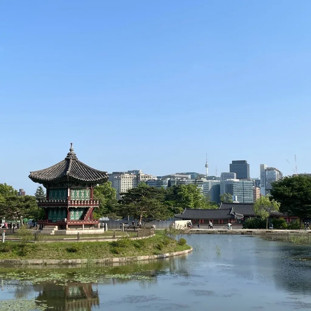Hyangwonjeong Pavilion with the modern Seoul skyline behind it