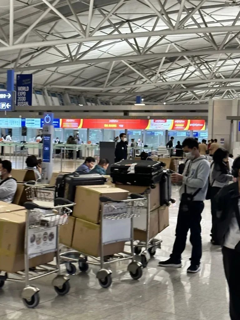 Luggage carts loaded with travel suitcases and boxes at Incheon International Airport