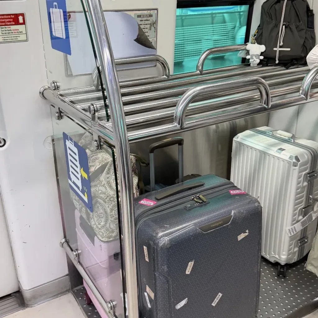 Suitcases stored in luggage racks inside the AREX airport express train