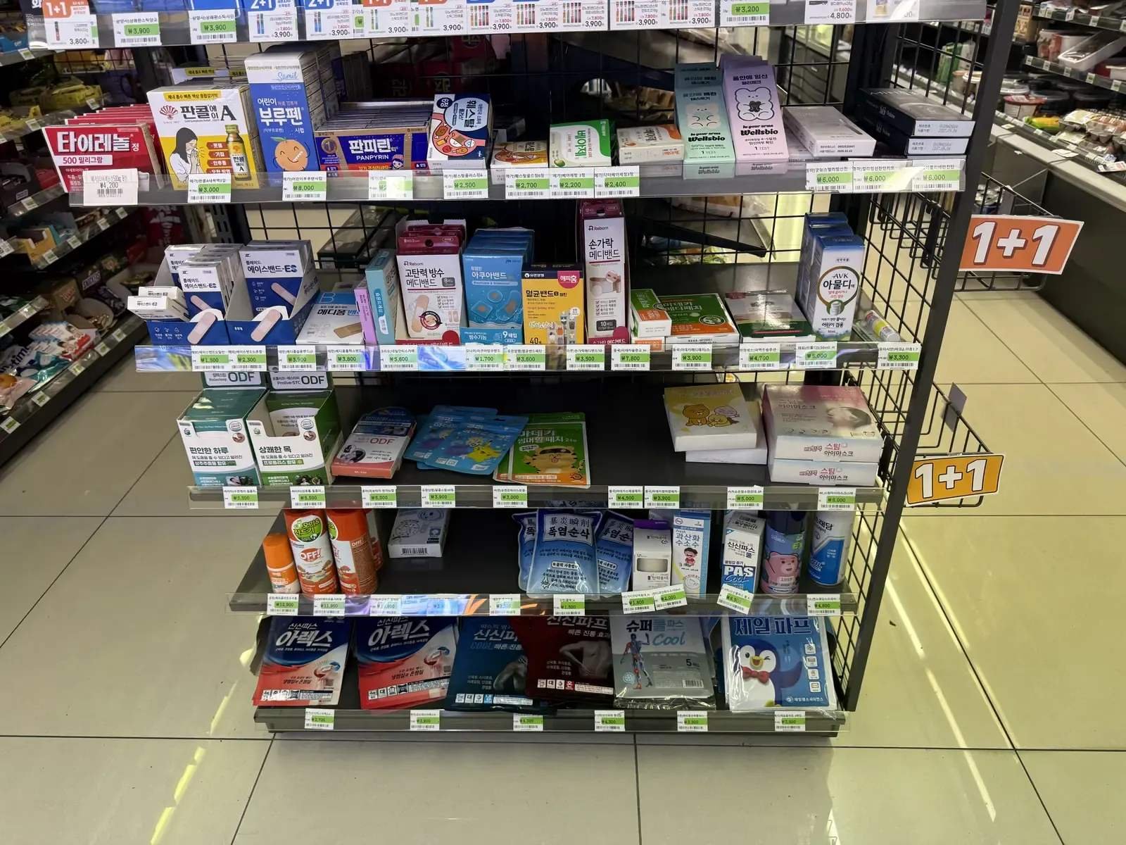 Over-the-counter emergency medicine and pain relief patches on a Korean convenience store shelf