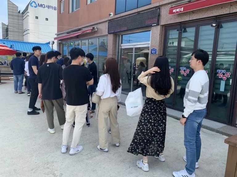 Crowd waiting in line outside a popular trendy restaurant in Korea