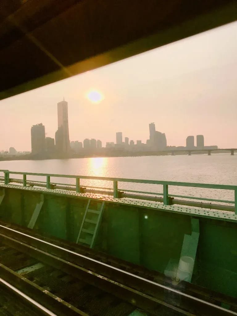 Scenic view from a train window crossing the Han River railway bridge in Seoul