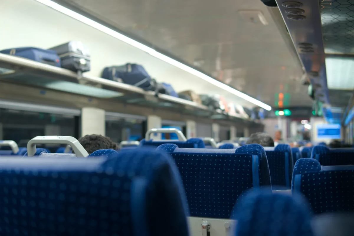 Luggage stored on train overhead racks and designated suitcase storage spaces on KTX