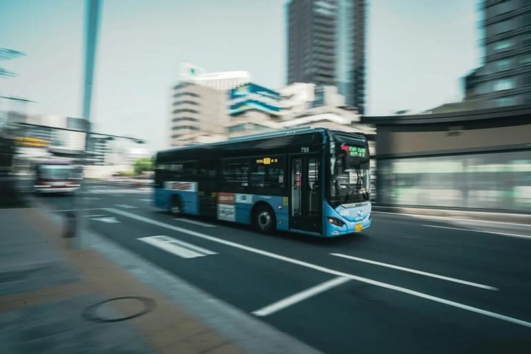 Blue Seoul city bus driving on a street in central Seoul