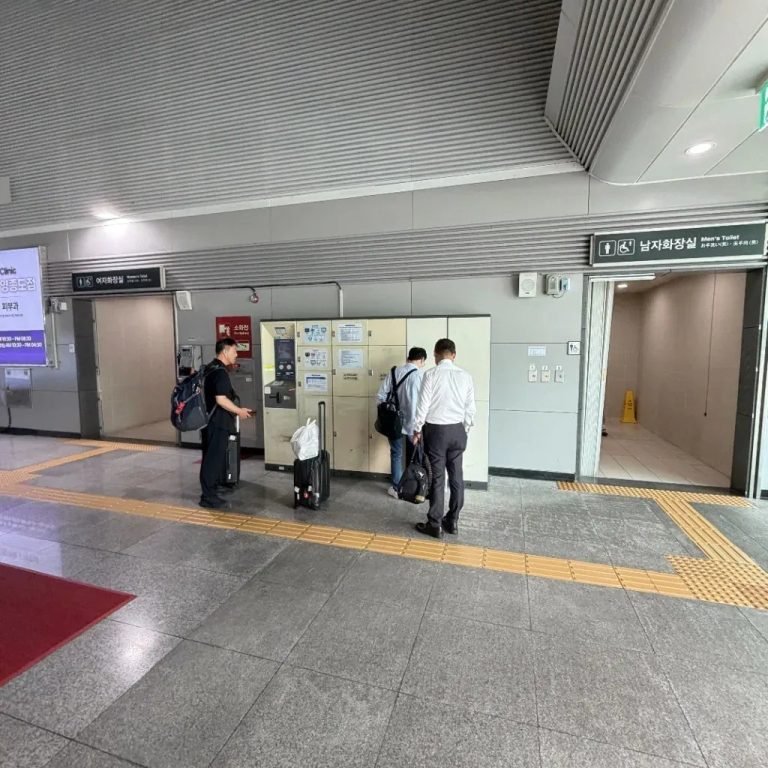 Travelers operating electronic luggage storage lockers at a Seoul transit station