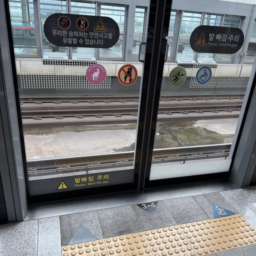 Seoul subway platform screen door with car and door number 3-4 on the floor
