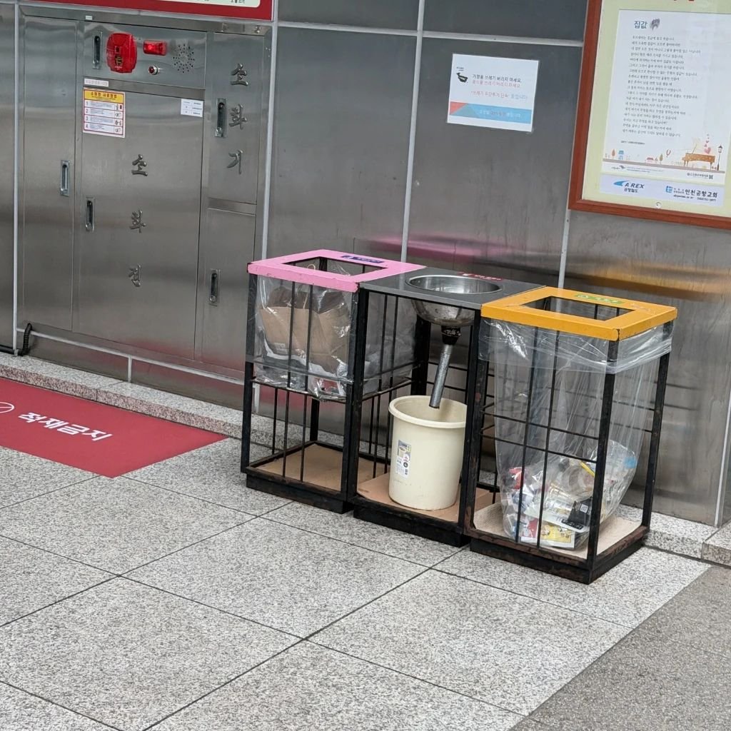 Designated recycling and liquid waste disposal station inside a Seoul transit station