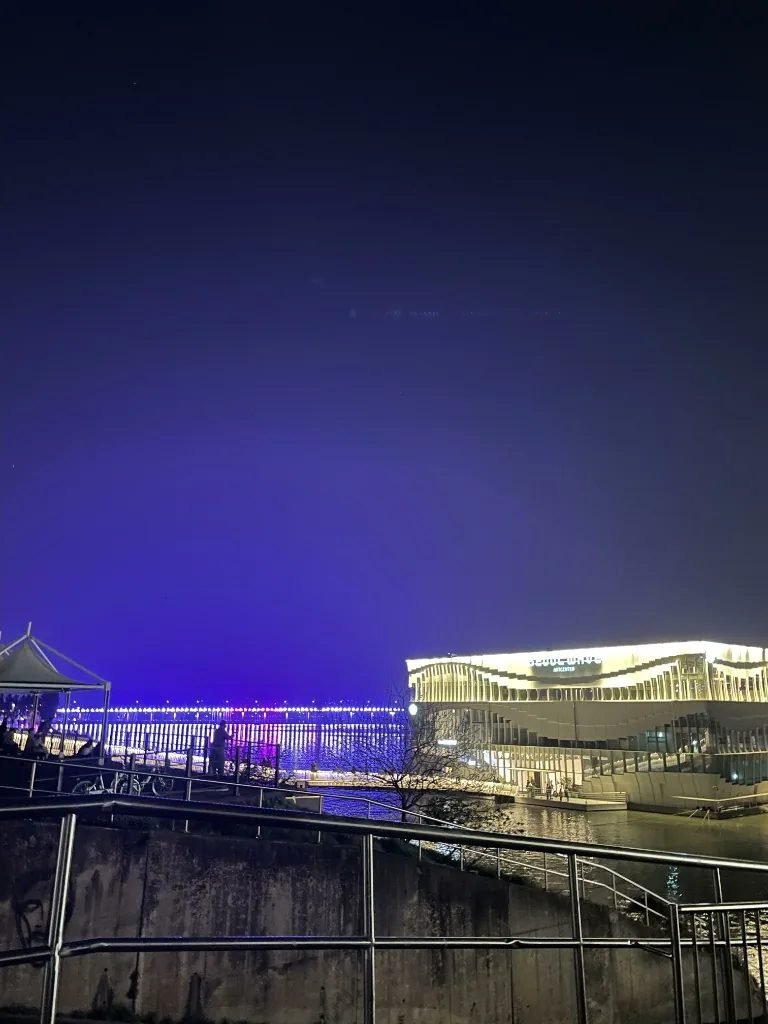 Illuminated floating Seoul Wave Art Center on the Han River at night in Seoul