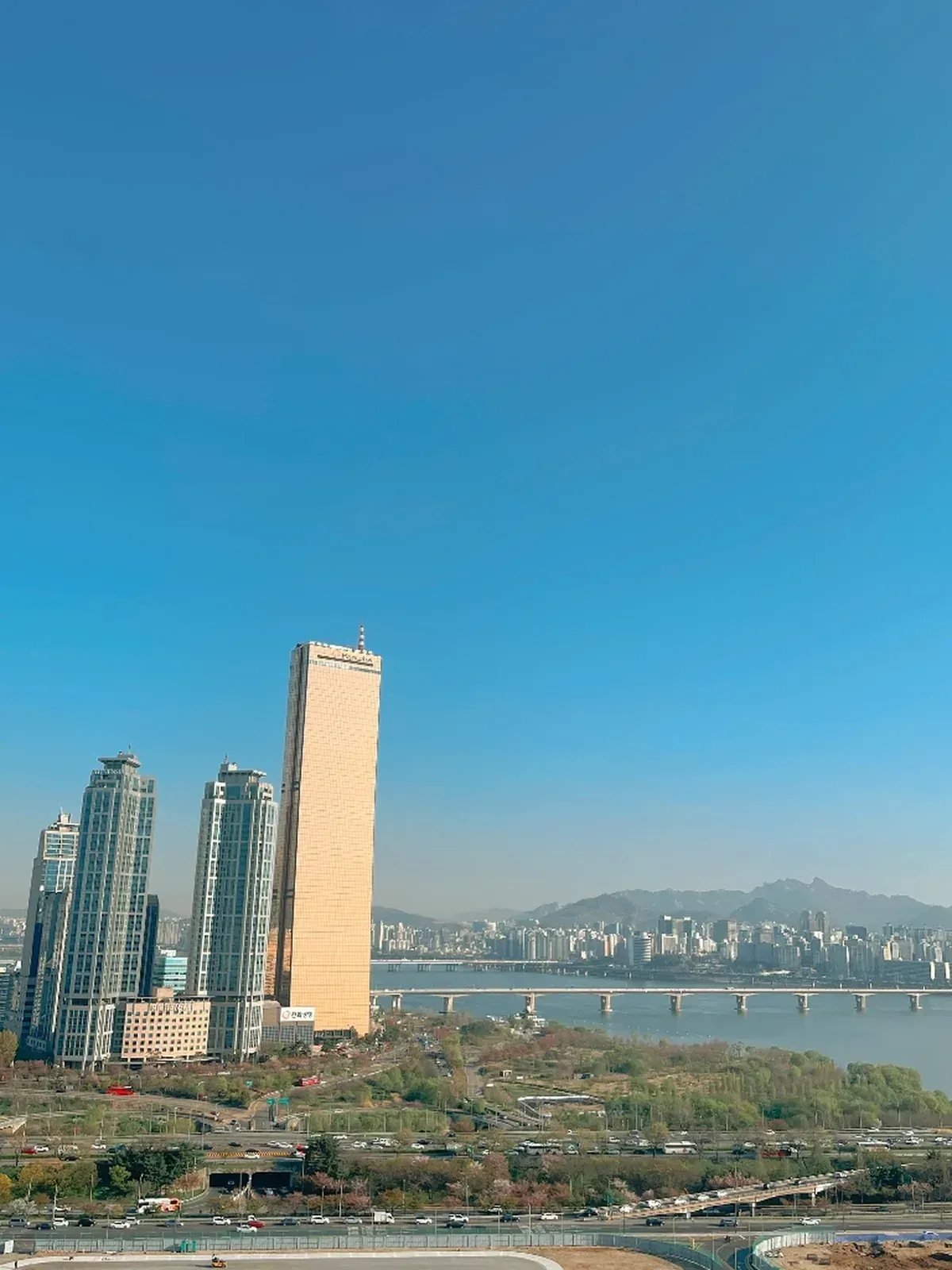 Aerial view of Yeouido 63 Building and Han River cityscape on a clear sunny day in Seoul