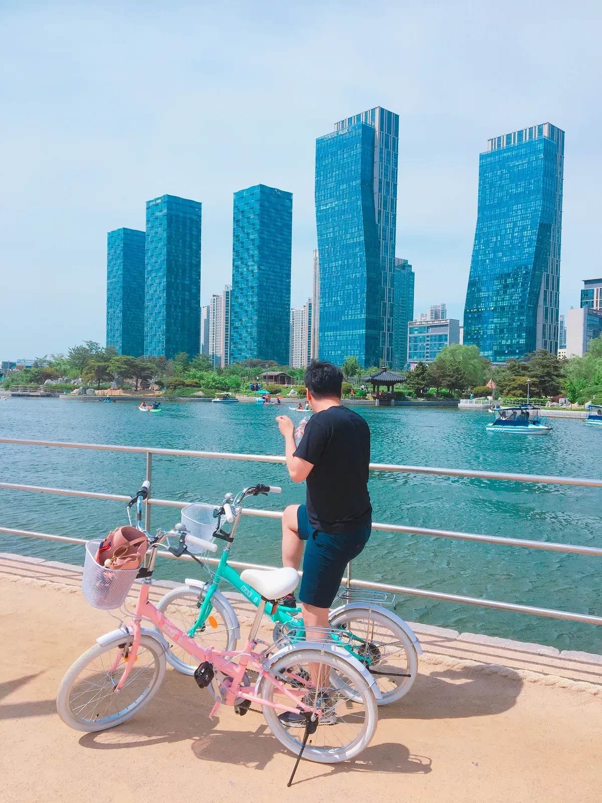 Bicycle beside the canal at Songdo Central Park with modern towers