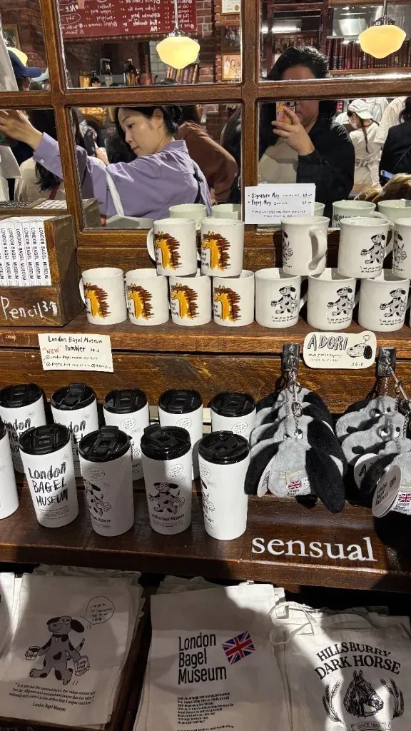 Exclusive mugs tumblers and tote bag merchandise on display at a trendy Seoul bakery cafe