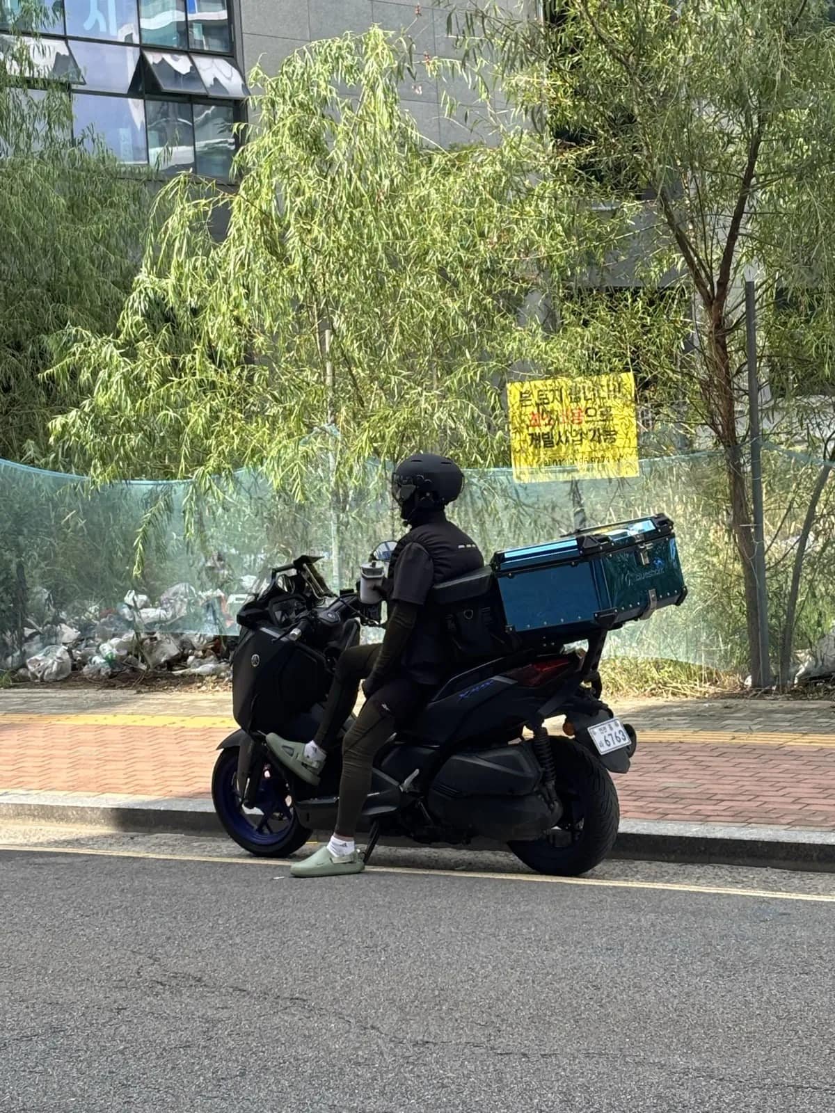 A delivery rider on a scooter in Korea